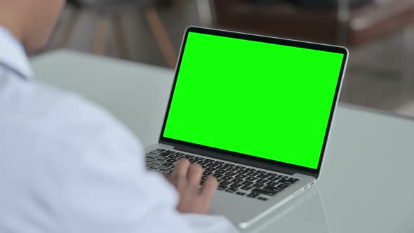 Rear View of African Doctor using Laptop with Open Screen