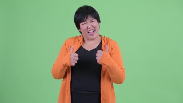 Happy Young Overweight Asian Woman Giving Thumbs Up Ready for Gym