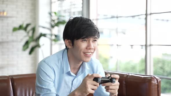 young worker man relaxing time with playing a video game on a joystick, watching the game