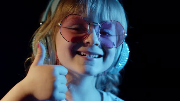 Portrait of Trendy Stylish Girl Looking at Camera Smiling Child Kid in Neon Light at Disco Club