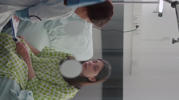 Vertical Video Sick Woman Talking with Doctors While Sitting on Bed During Sickness Recovery