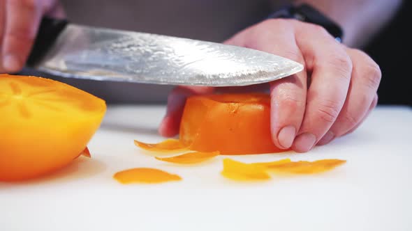 cutting persimmons with a table knife