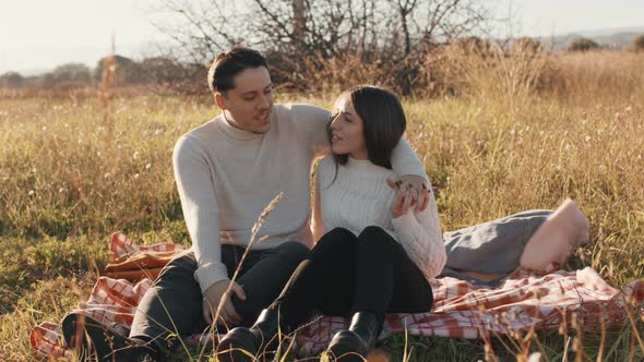 Couple in a Field On The Meadow at Sunset