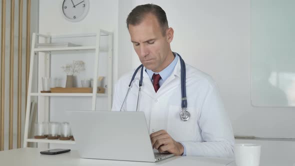 Doctor Typing On Laptop in Clinic