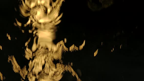 Stream of Water Falls on the Glass Window in Slow Motion on a Black Background. The Streams of Water