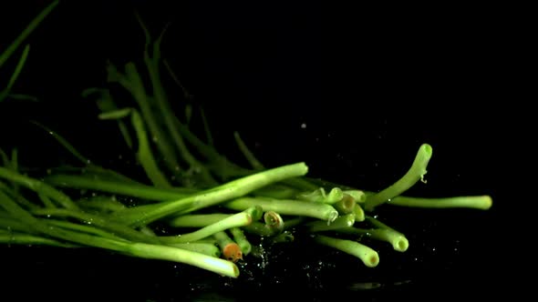 Super Slow Motion Pile Green Onion Falls on the Table