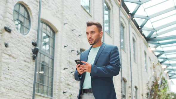 Young successful caucasian businessman works outdoor