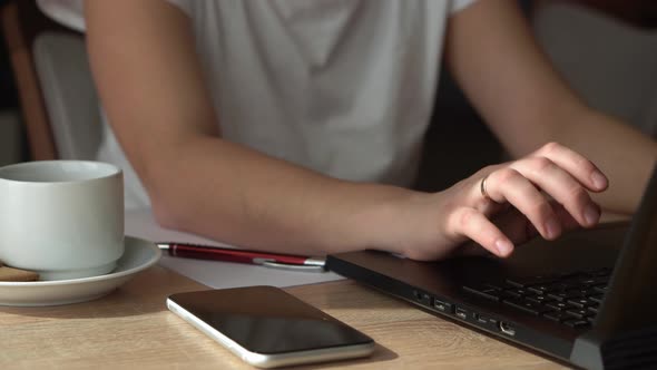 Close Up Hands Of Young Woman Chatting On Laptop At Home In Living Room