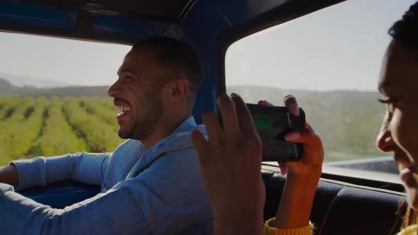 Young couple on a road trip in their pick-up truck