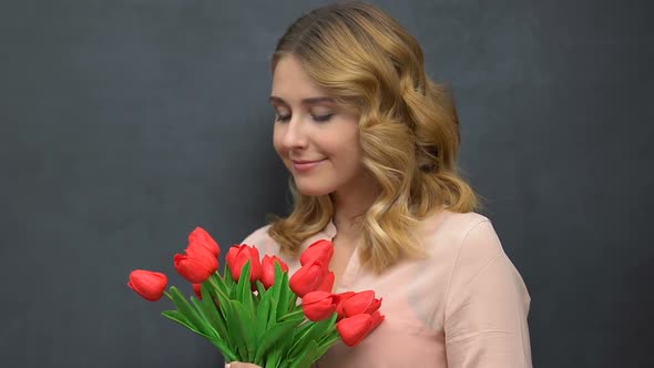 Pretty Lady Holding Bunch of Tulips Isolated on Blackboard Background, Allergy