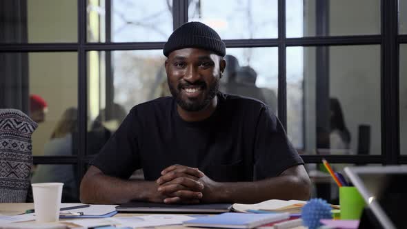 Smiling African American Man Posing at Workstation