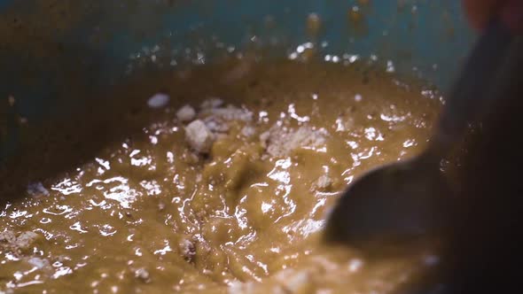 Pastry chef mixing cake batter in a bowl in slow motion