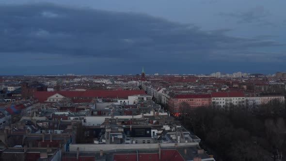 Establisher Shot of Rooftop of Traditional Brick Houses Across Street Surrounded with Trees on a