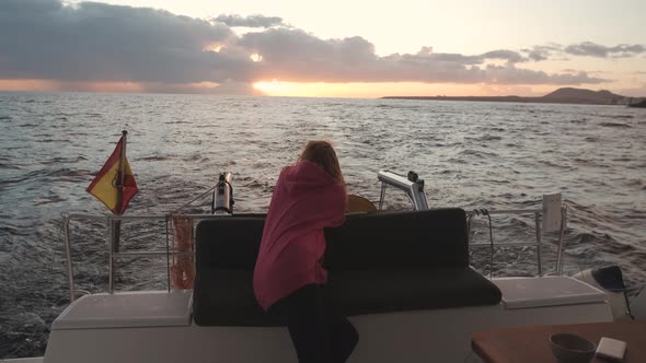 Beautiful Woman on a Luxury Yacht Enjoying the Best Sunset or Sunrise in the Ocean During a Cruise