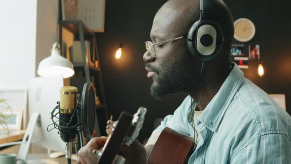 African American Musician Recording Song at Home Studio