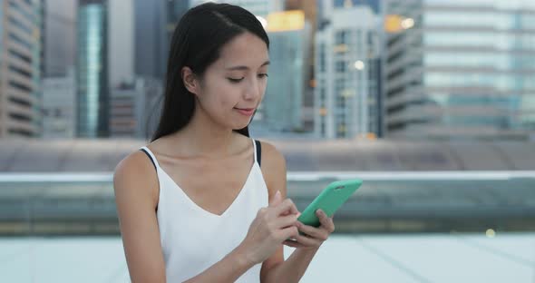 Woman use of smart phone in the evening 