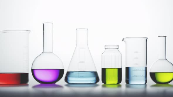 Laboratory glassware with colorful liquids inside on a light background looping.