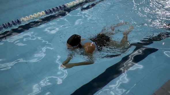 Slow Motion Of Young Graceful Woman Swimmer Performing Breaststroke Techniques