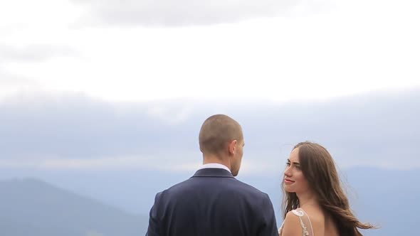 Happy Brides Bride and Groom Overlooking Beautiful Green Mountains