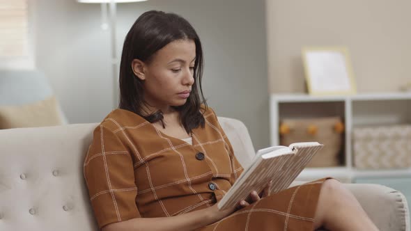 Mixed-Race Woman Reading Book Smiling