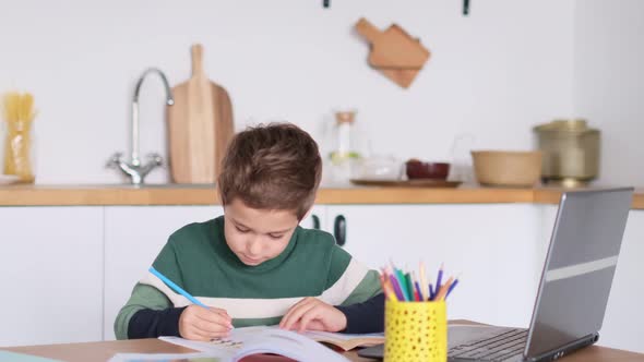 Boy is Studying Mathematics at an Online School Showing the Answer to the Question Via Video