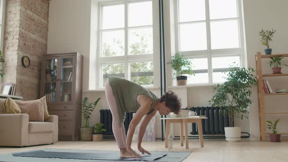 Woman Stretching on Yoga Mat at Home