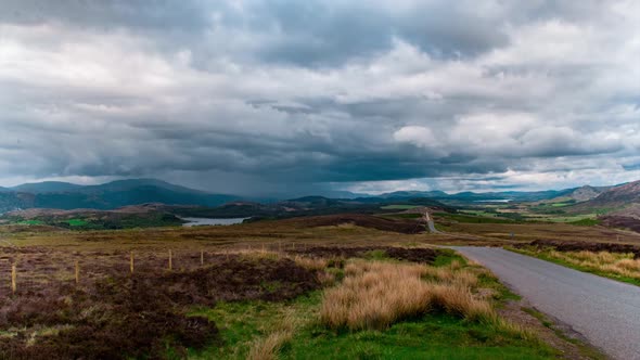 Cinematic timelapse of scottish road with highland fields in background