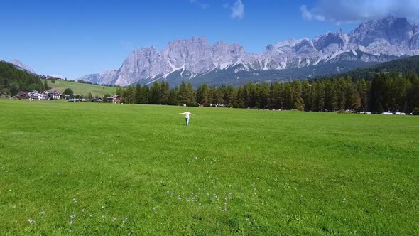 Woman Having Fun on Valley with Beautiful Scenery of Italian Dolomites in the Background