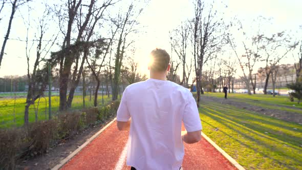 The athlete is running in the park.