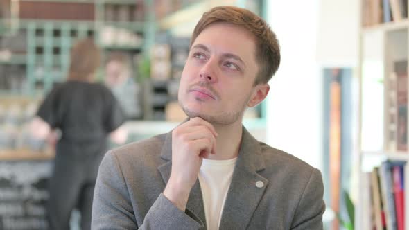 Portrait of Pensive Young Man Thinking