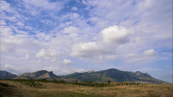 Mountains Against the Blue Sky with White Clouds. Cirrus Clouds Run Across the Blue Sky