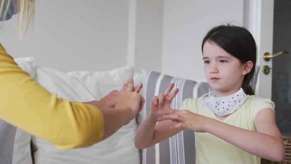 Mother and daughter talking to each other through sign language