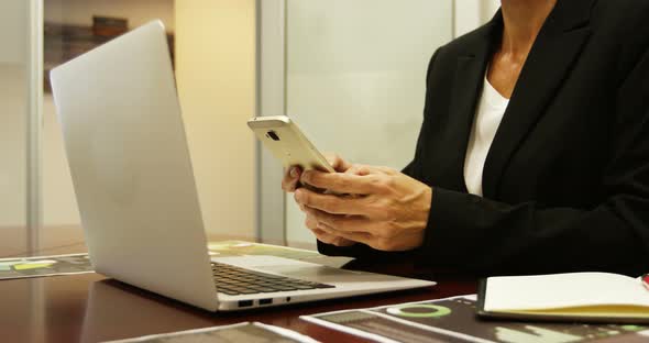 Businesswoman Using Mobile Phone at Desk 4k