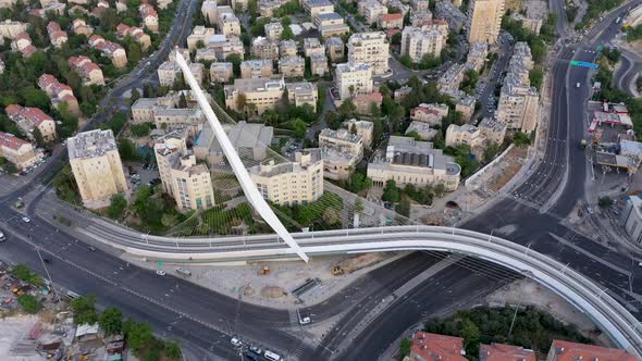 Aerial tilt down shot over the Chords Bridge, car at the intersection, Jerusalem Israel