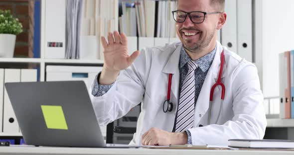 Doctor Waving His Hand at Laptop Screen and Conducting Online Consultation to Patient  Movie