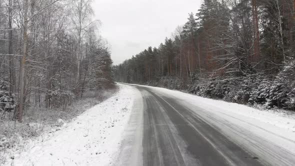 Driving Low Over a Slippery Icy Road on a Cloudy Winter Day