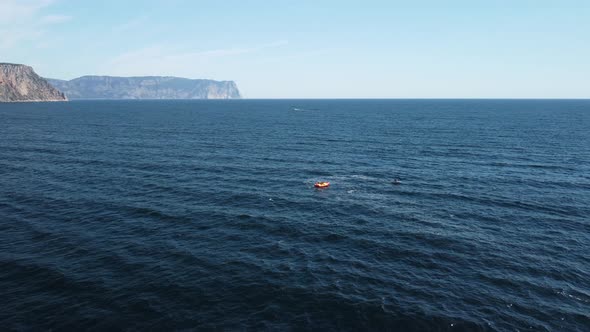 Happy People Swim on Air Mattress Behind a High Speed Water Bike