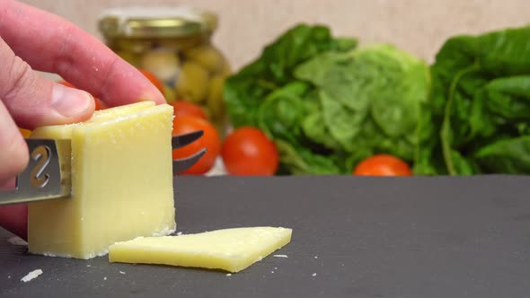 Slicing Cheese Parmesan Chopping Parmesan Cheese with a Knife on a Cutting Board Preparing Healthy