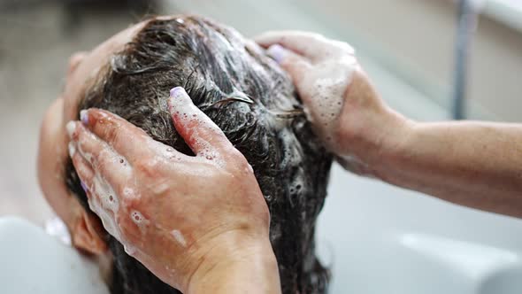 Close Up View of Washing Hair in Sink in Beauty Salon