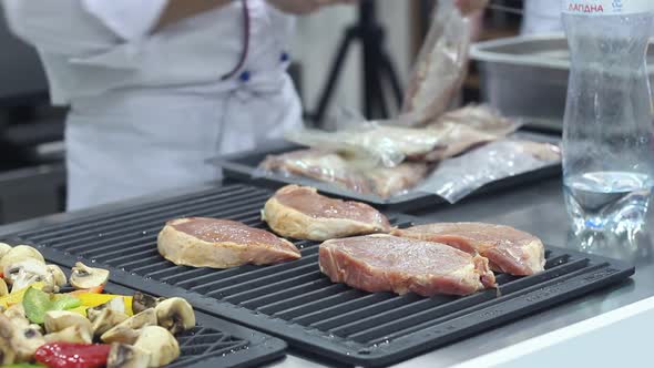 Chef Works With The Meat In The Kitchen