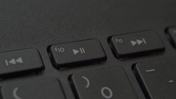 Finger Presses the "Play + Pause" Button on Your Keyboard