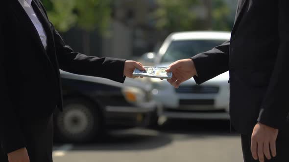 Business Woman Giving Bunch of Dollars to Man in Suit, Bribe Taking, Corruption