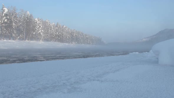 River Snow Covered Trees Along River Bank