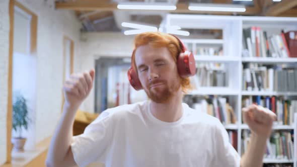 Man Listening Music in Headphones and Dancing in Office