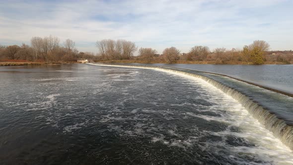 Water control dam on wide shallow river.