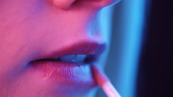 Sexy Female Lips in Neon Light Closeup