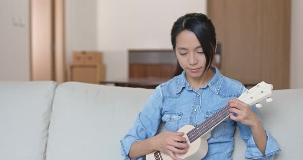 Woman Play with Ukulele at Home