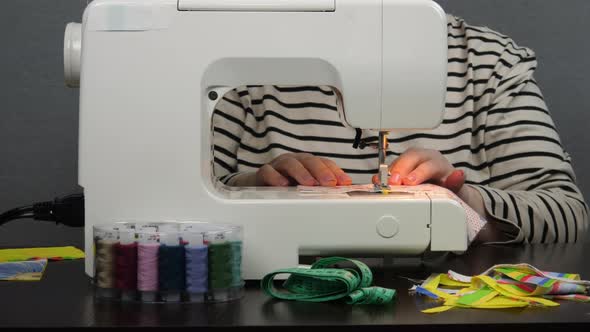 Fashion designer sewing together pieces of fabric