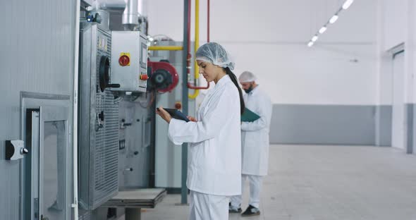 Commercial Looking Engineer Woman in a Big Bakery