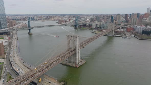 Aerial Footage of Heavy Traffic on Brooklyn and Manhattan Bridges Over River